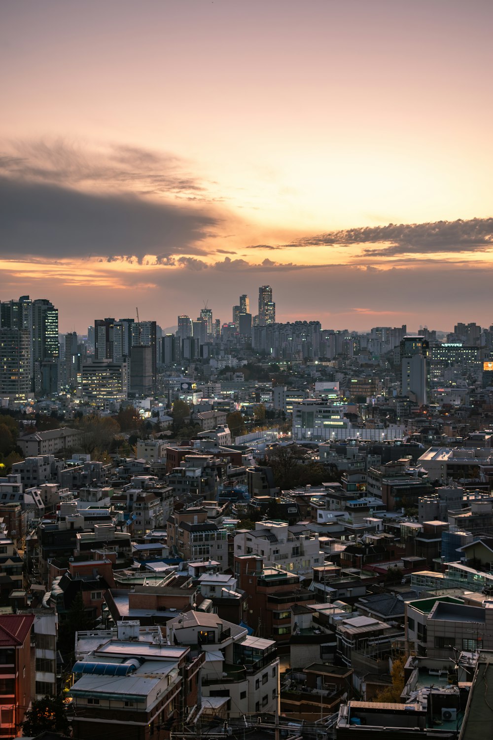 a view of a city at sunset from a hill