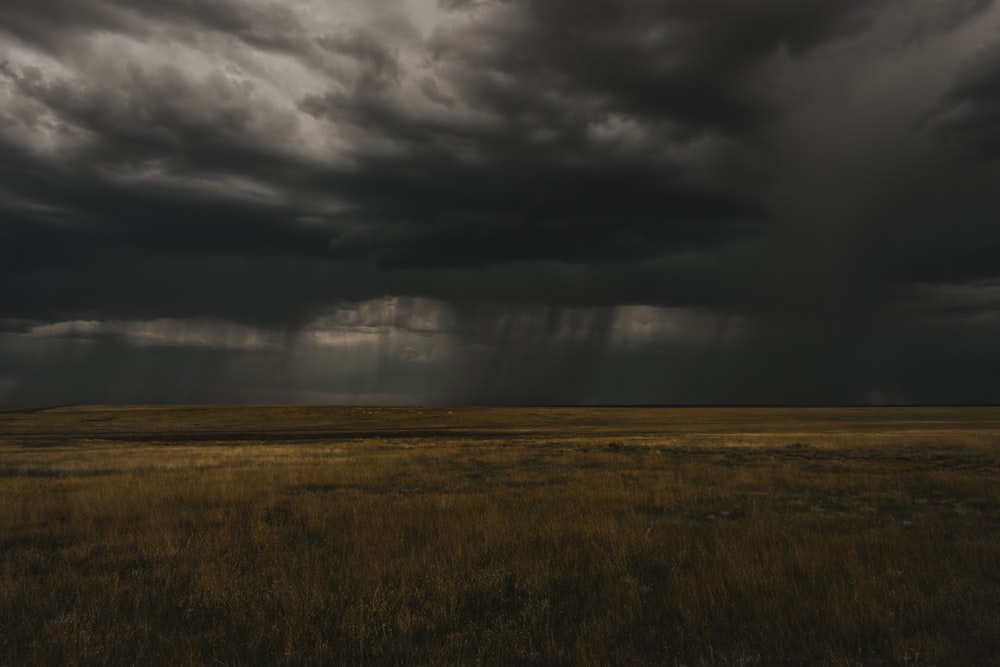 a large open field under a cloudy sky