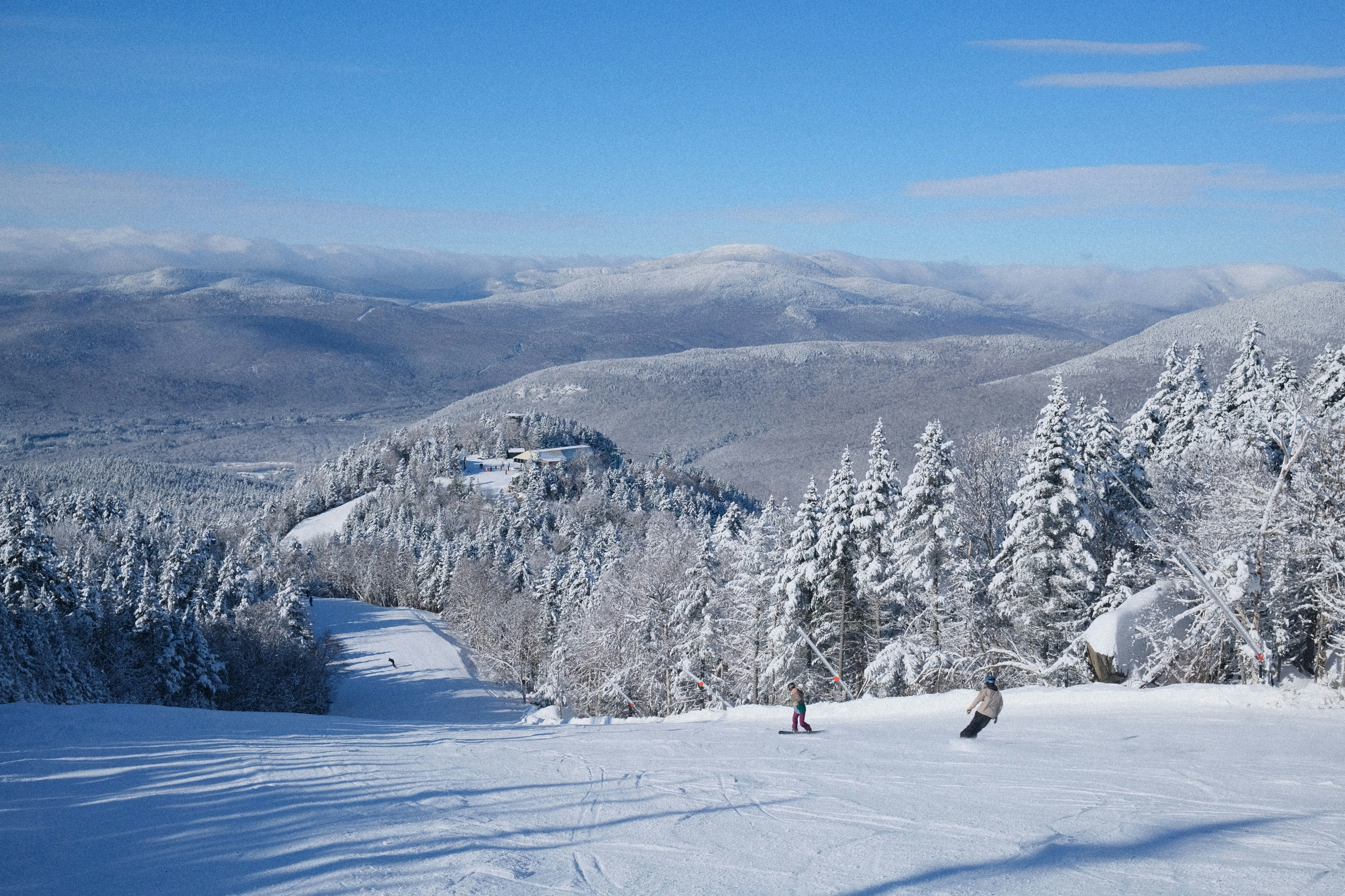 a group of people riding skis on top of a snow covered slope