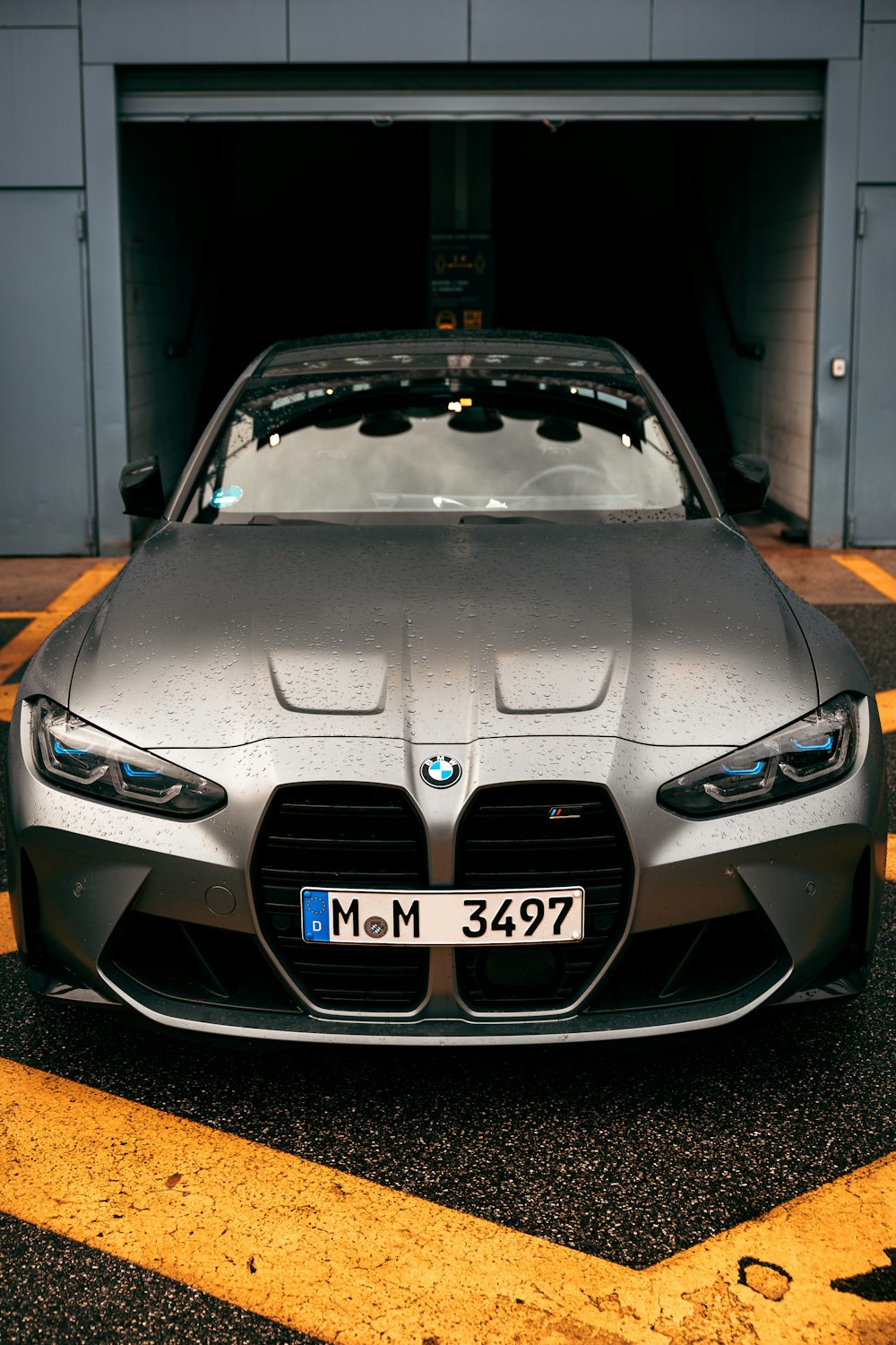 a silver sports car parked in a parking garage