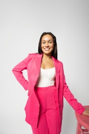 a woman in a pink suit posing for a picture