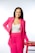 a woman in a bright pink suit posing for a picture