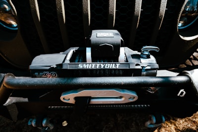 A close-up of a high-quality winch mounted on a truck.