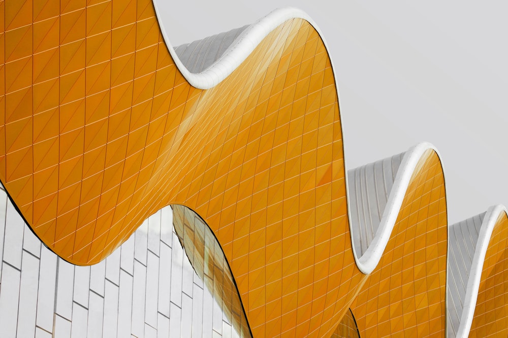 a yellow and white building with a curved design