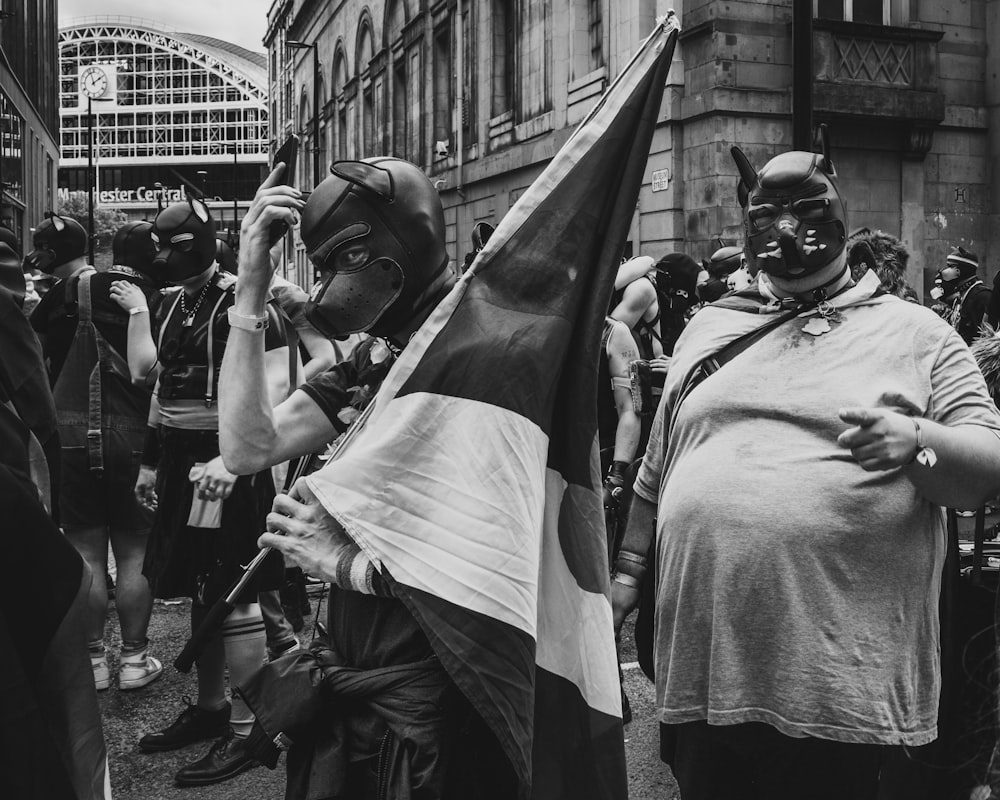 a group of people with masks on walking down a street