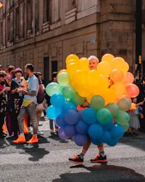 Brightly twisted balloon animals and hats crafted by the magician at a lively event.