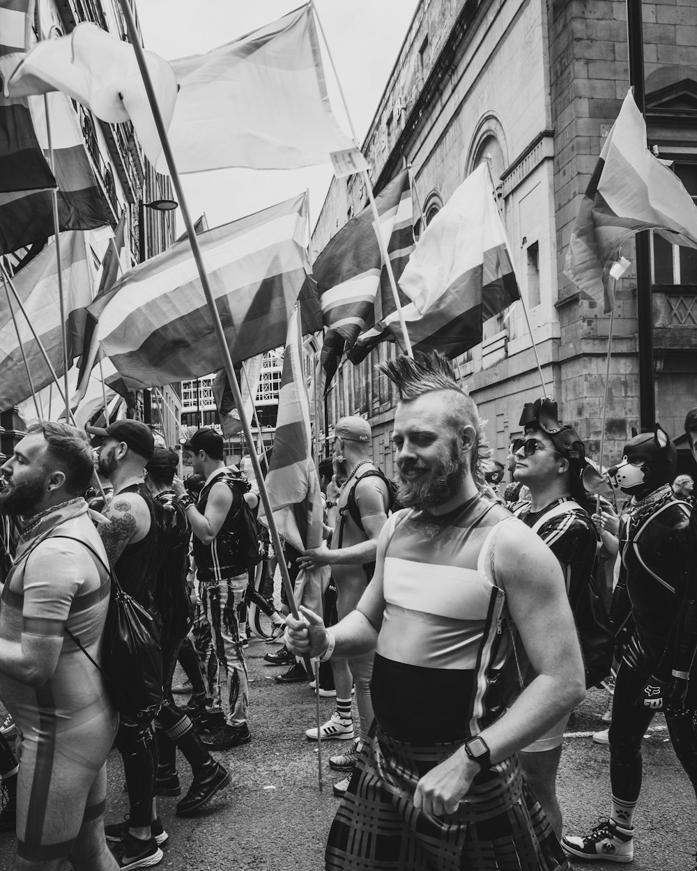 a group of people standing around each other holding flags