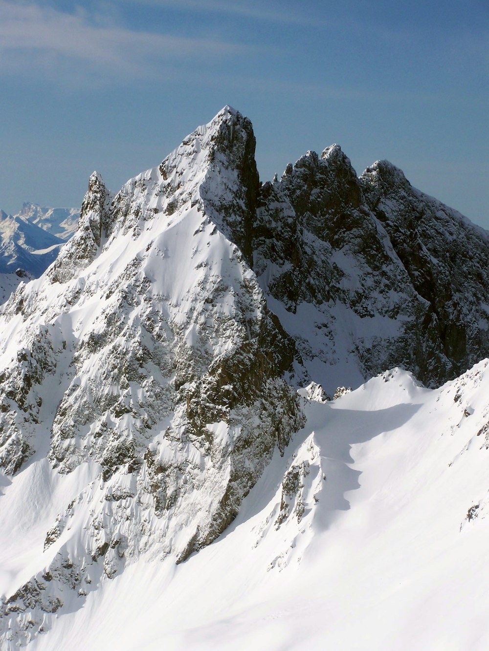 a snow covered mountain with a sky background