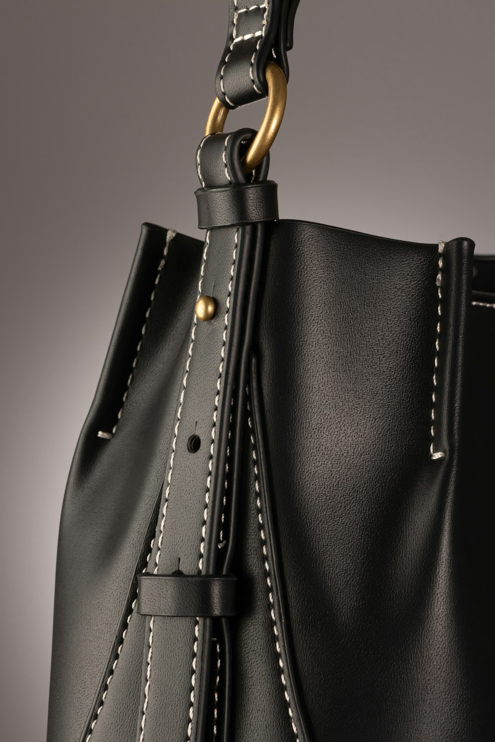 a black handbag with a gold handle