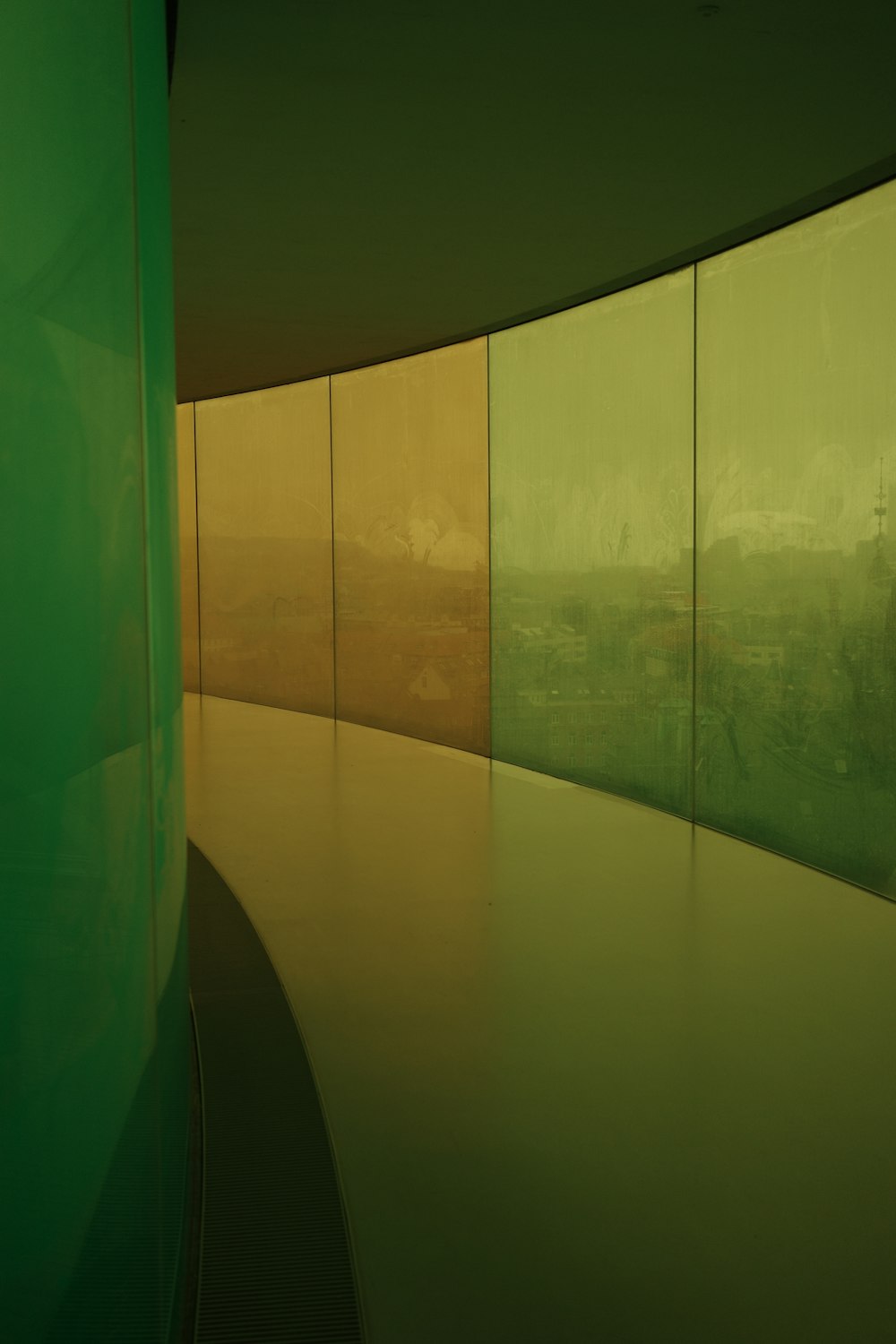 a curved wall in a room with green walls