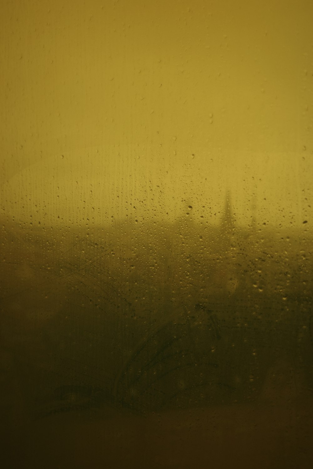 a view of a building through a rain covered window