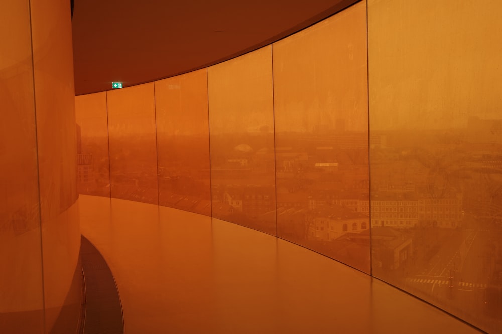 a wall of glass with a view of a city