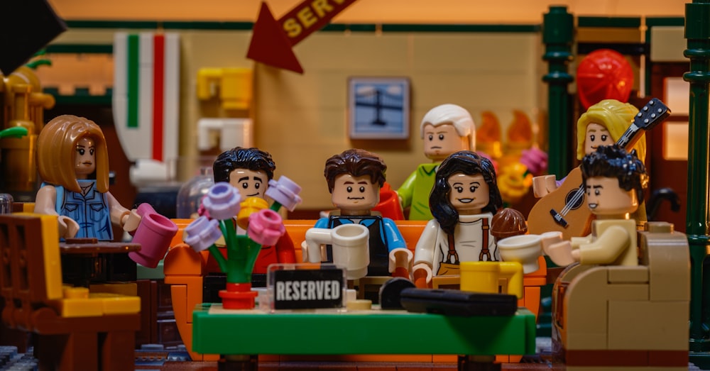 a group of lego people sitting around a table