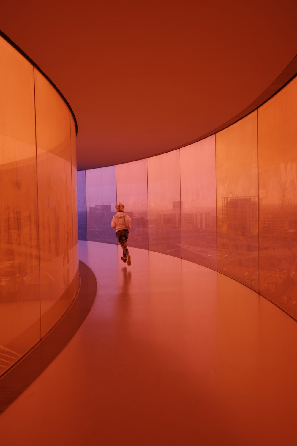 a person walking down a hallway in a building