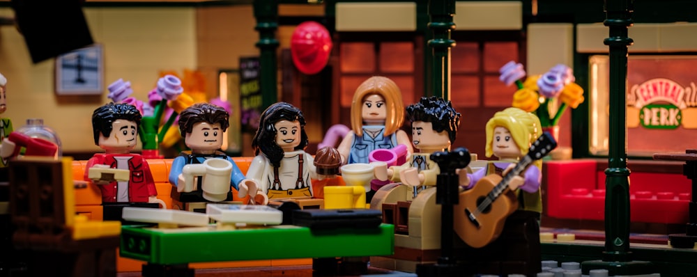 a group of lego people sitting around a table