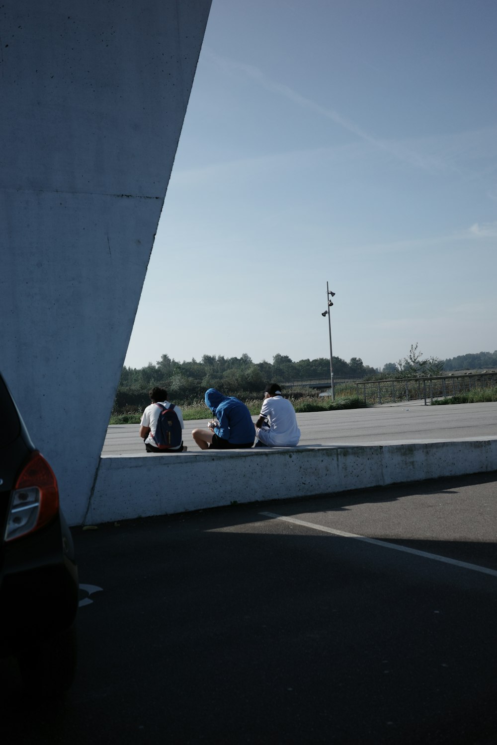 a group of people sitting on the side of a road