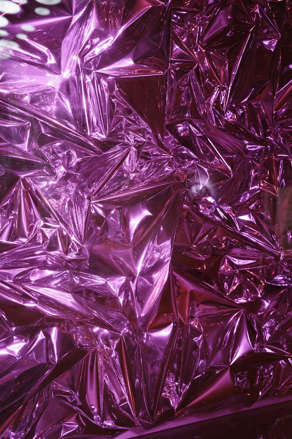 a close up view of a shiny purple surface