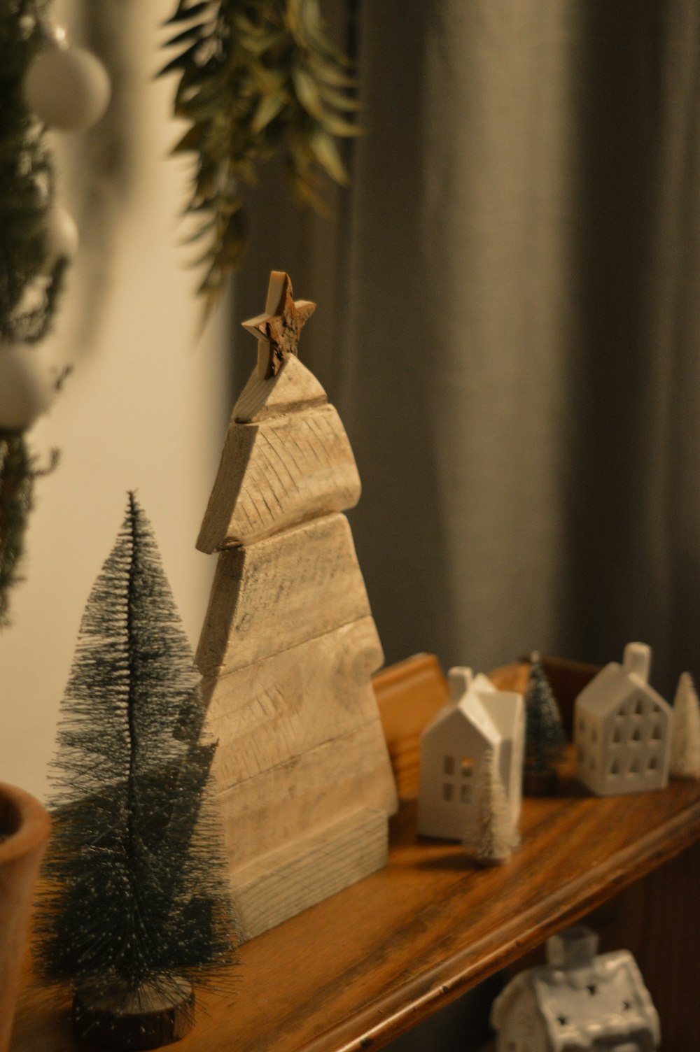 a wooden christmas tree sitting on top of a table