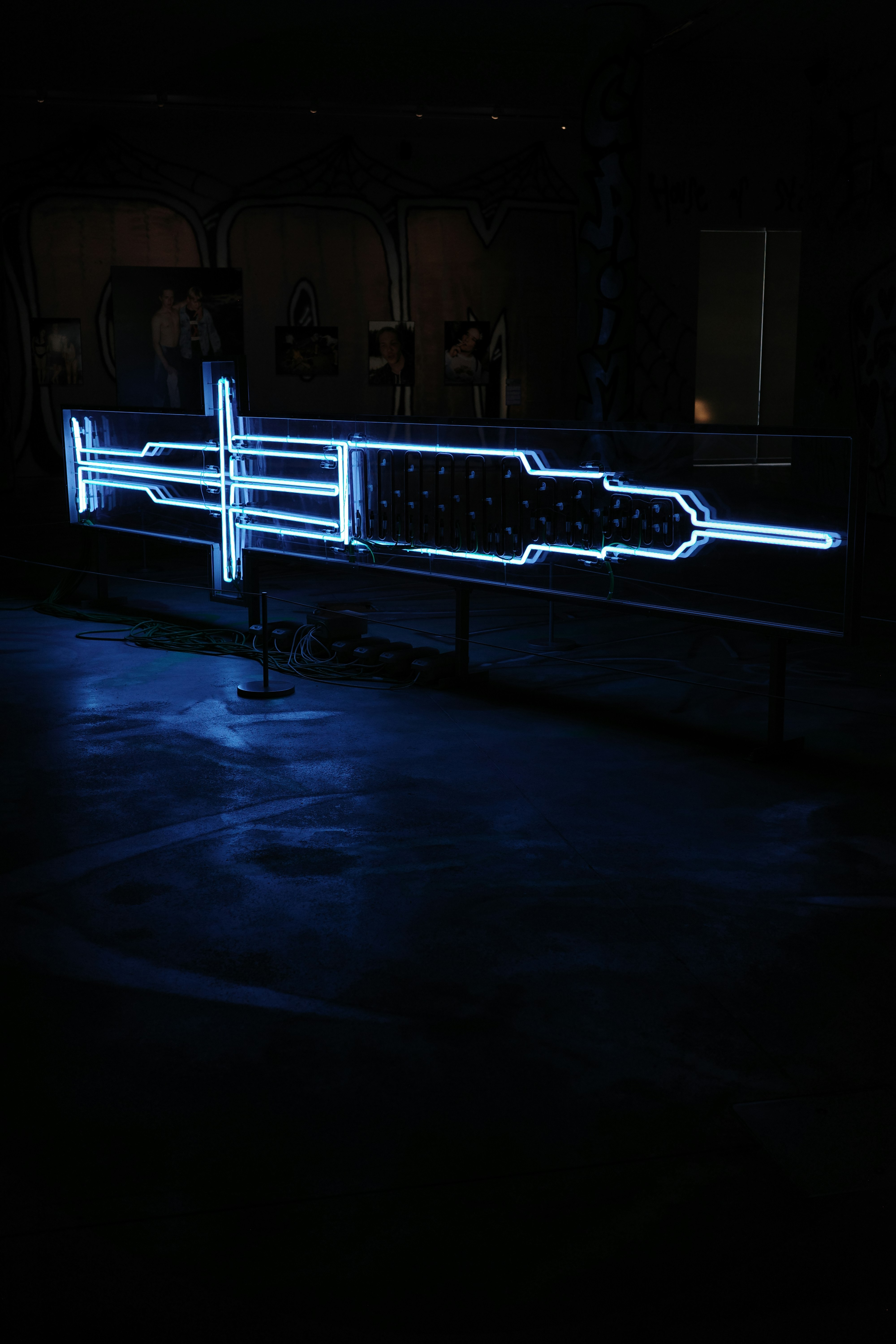 a neon sign in the middle of a dark room