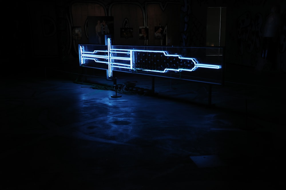 a neon sign sitting on top of a black floor