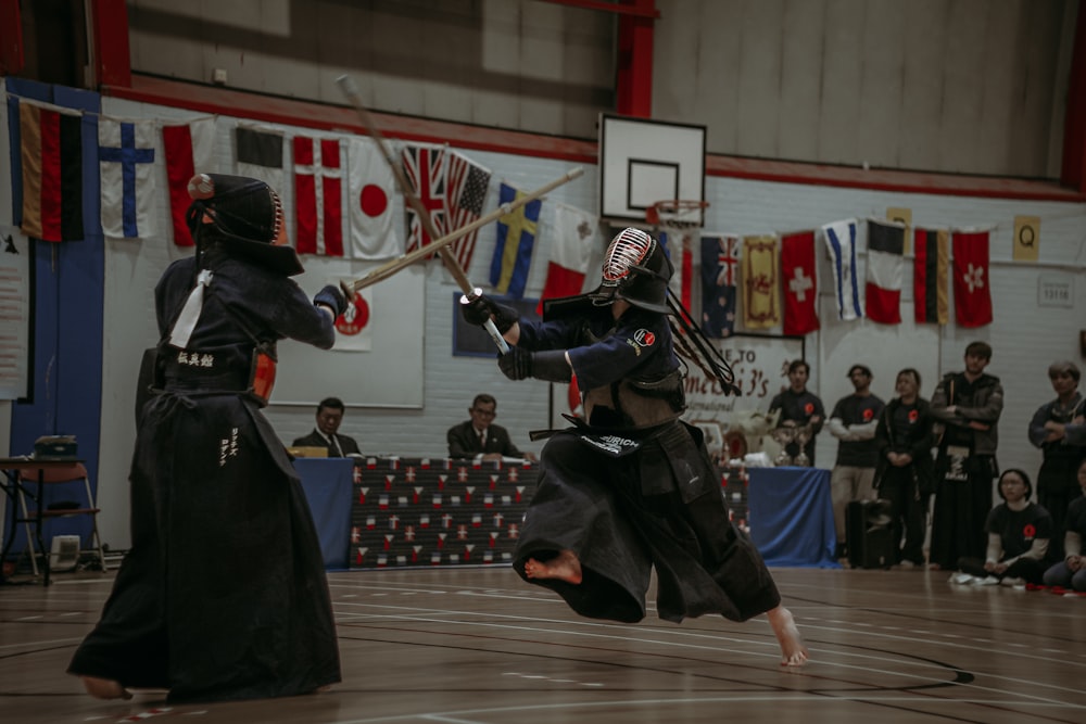 a couple of people on a court with a sword