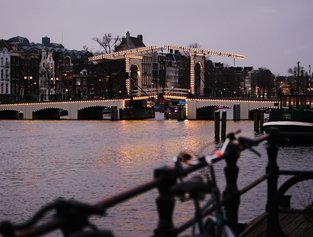 a bridge over a body of water with lights on it