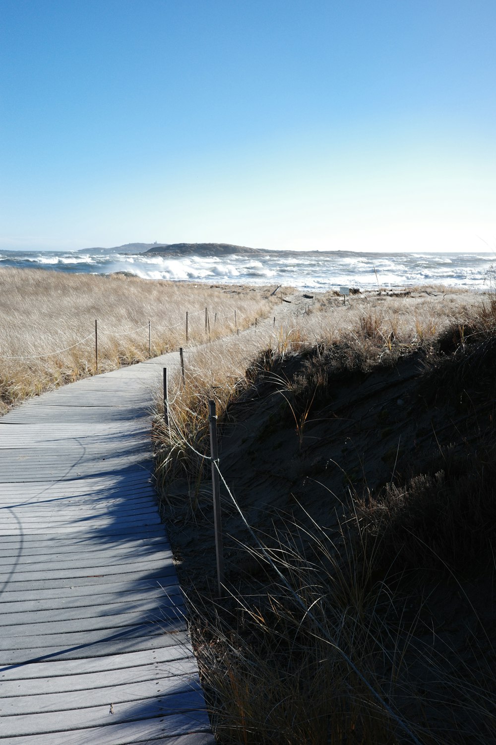 a wooden walkway leading to the beach