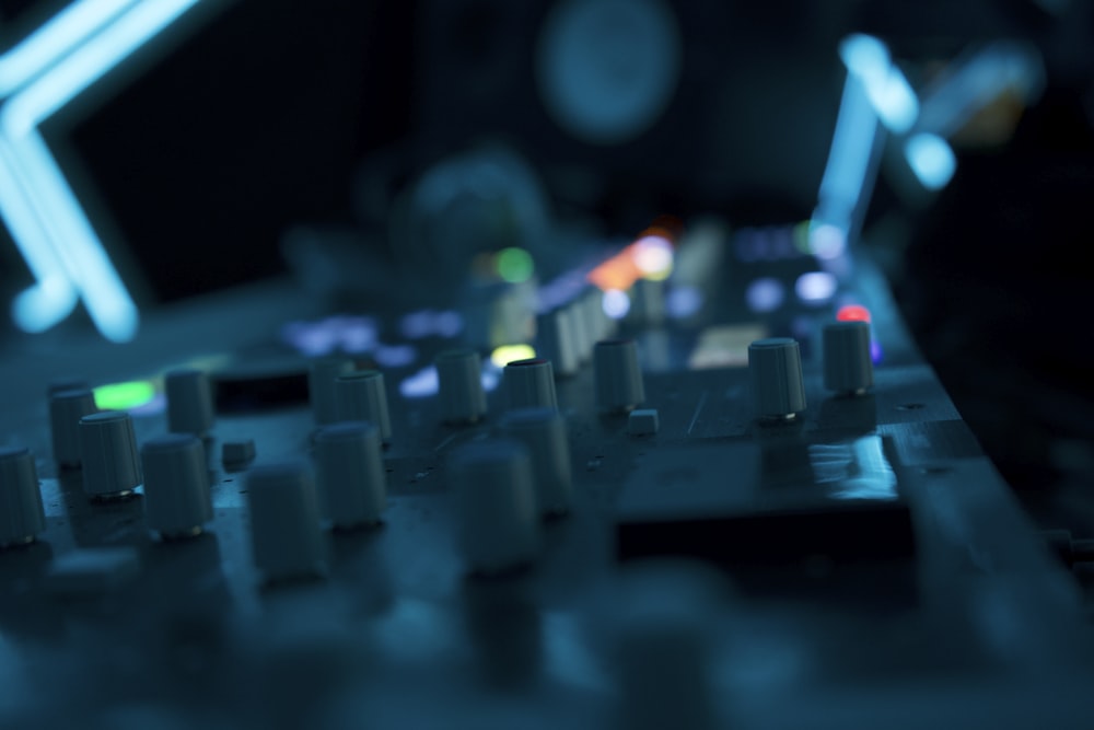 a close up of a mixing board in a recording studio