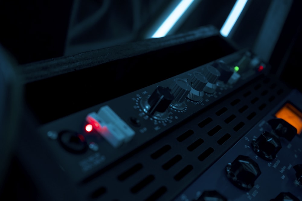 a close up of a control panel in a dark room