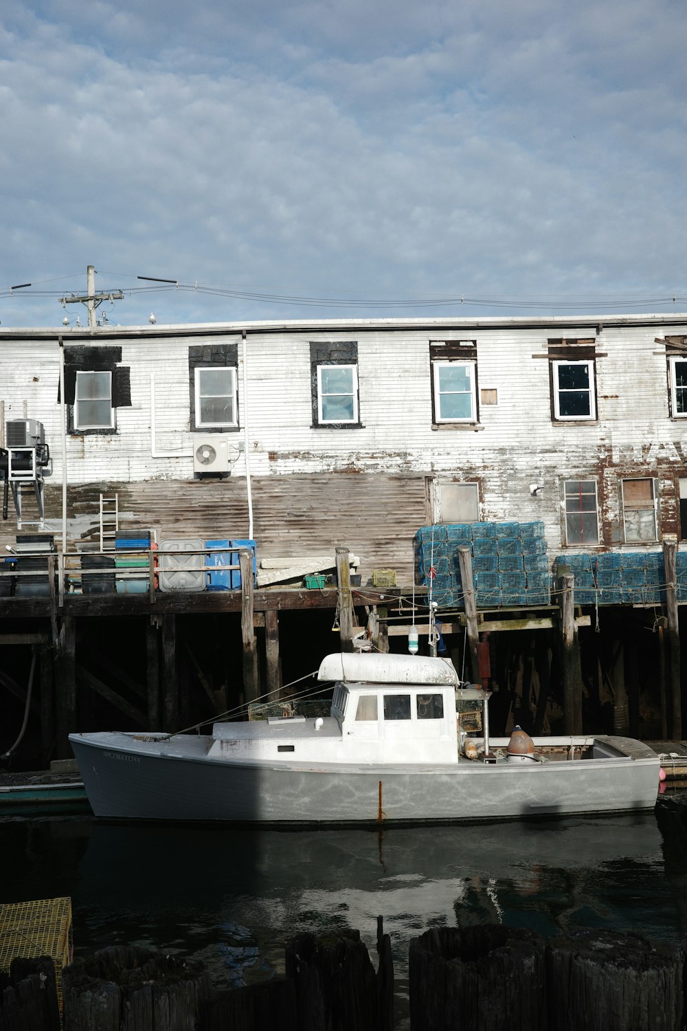 a white boat sitting in the water next to a building