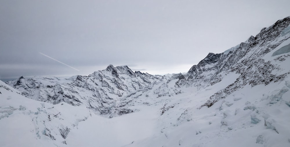 a mountain covered in snow with a sky background