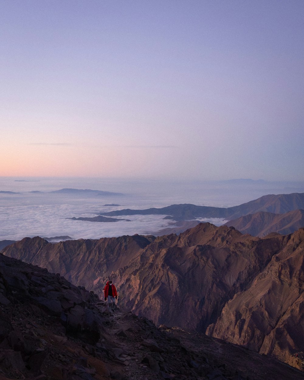 a couple of people standing on top of a mountain