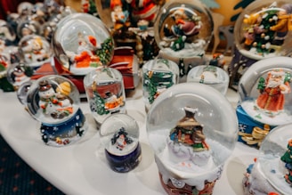 A collection of tumblers featuring holiday and seasonal decorations displayed on a rustic wooden table.