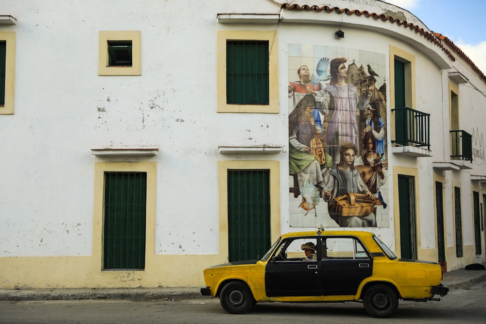 a yellow car parked in front of a building