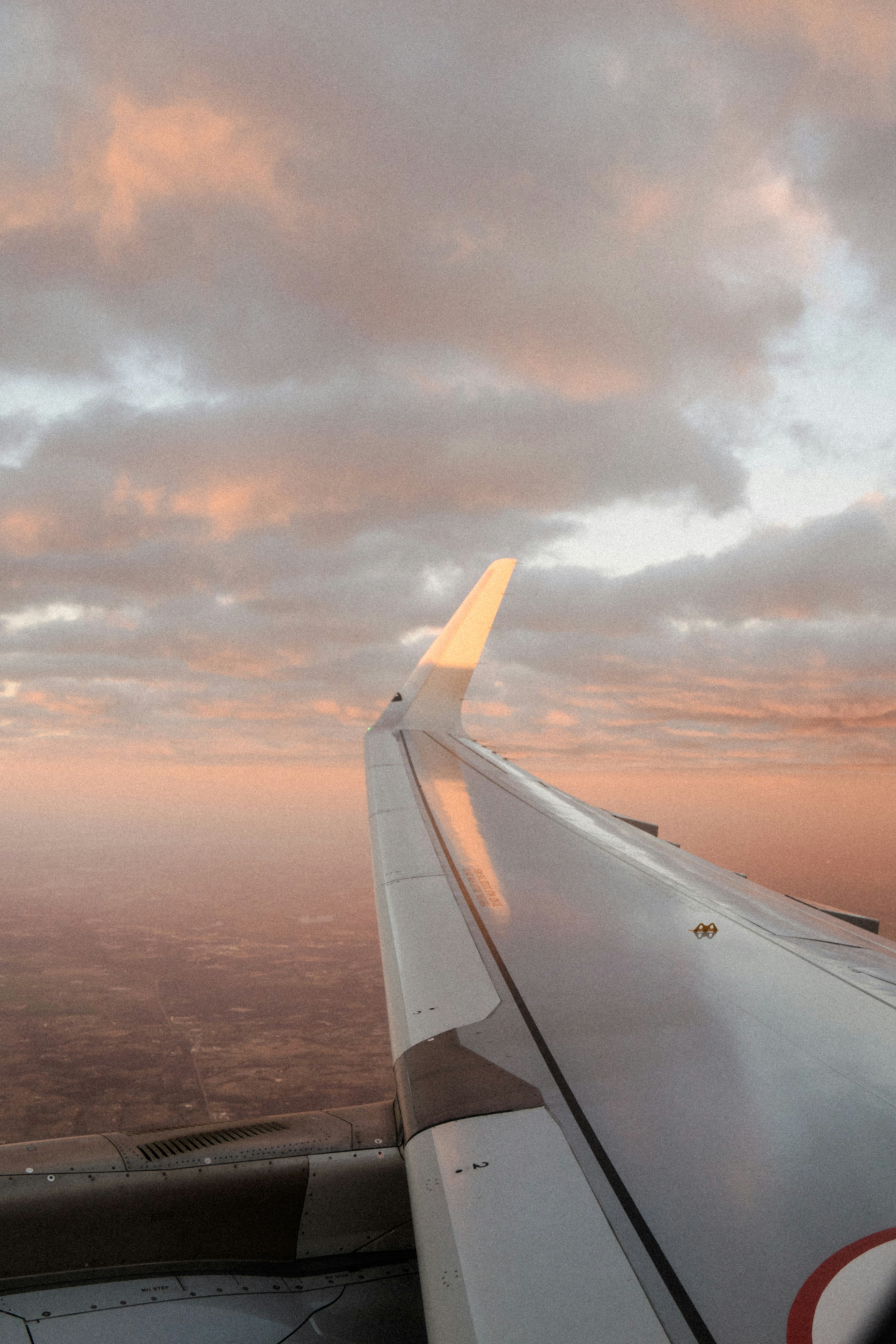 the wing of an airplane as it flies through the sky