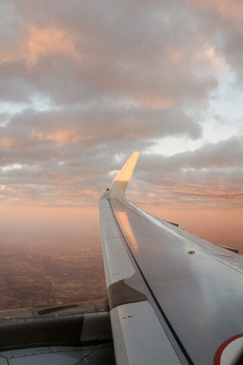 the wing of an airplane as it flies through the sky