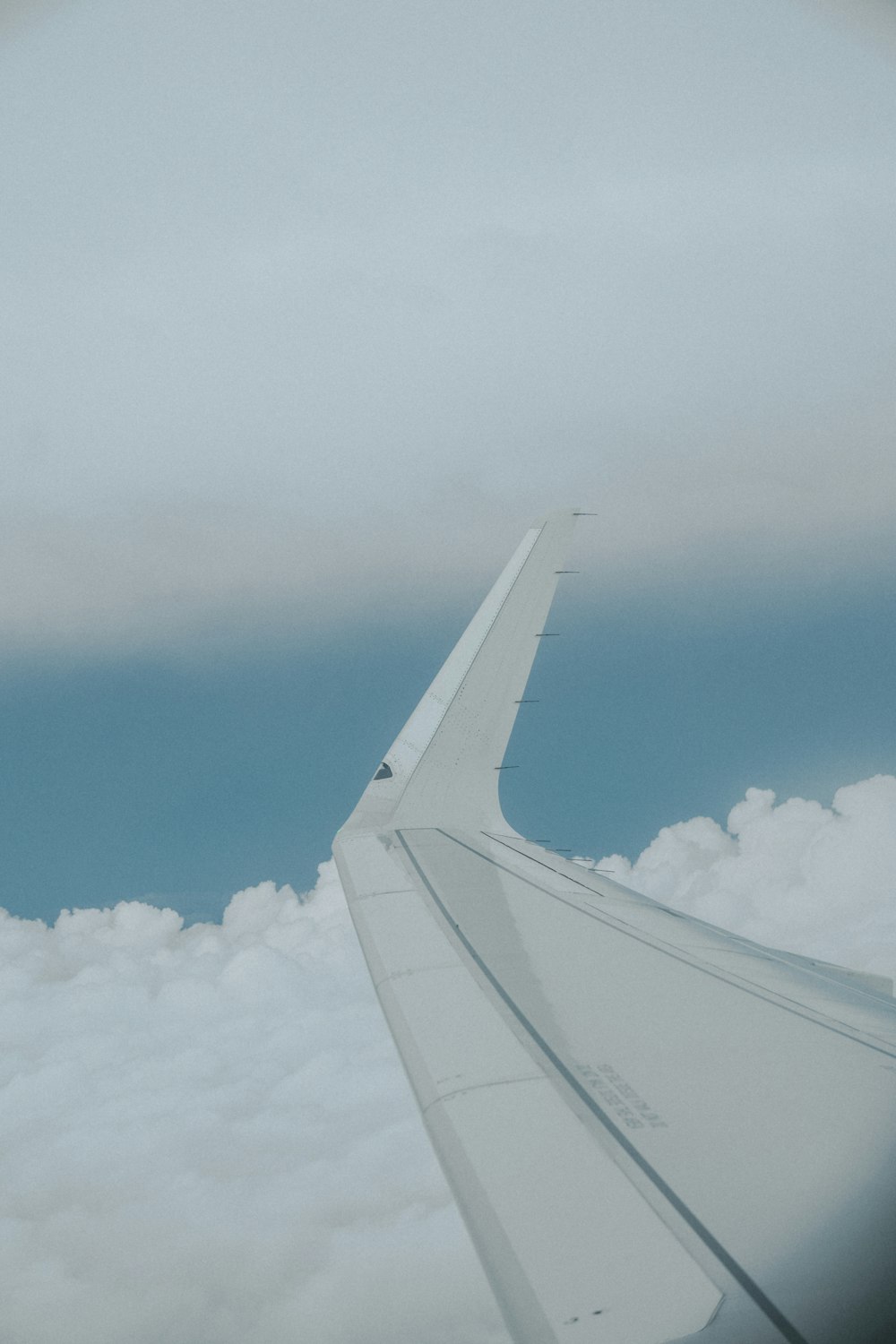 a view of the wing of an airplane in the sky