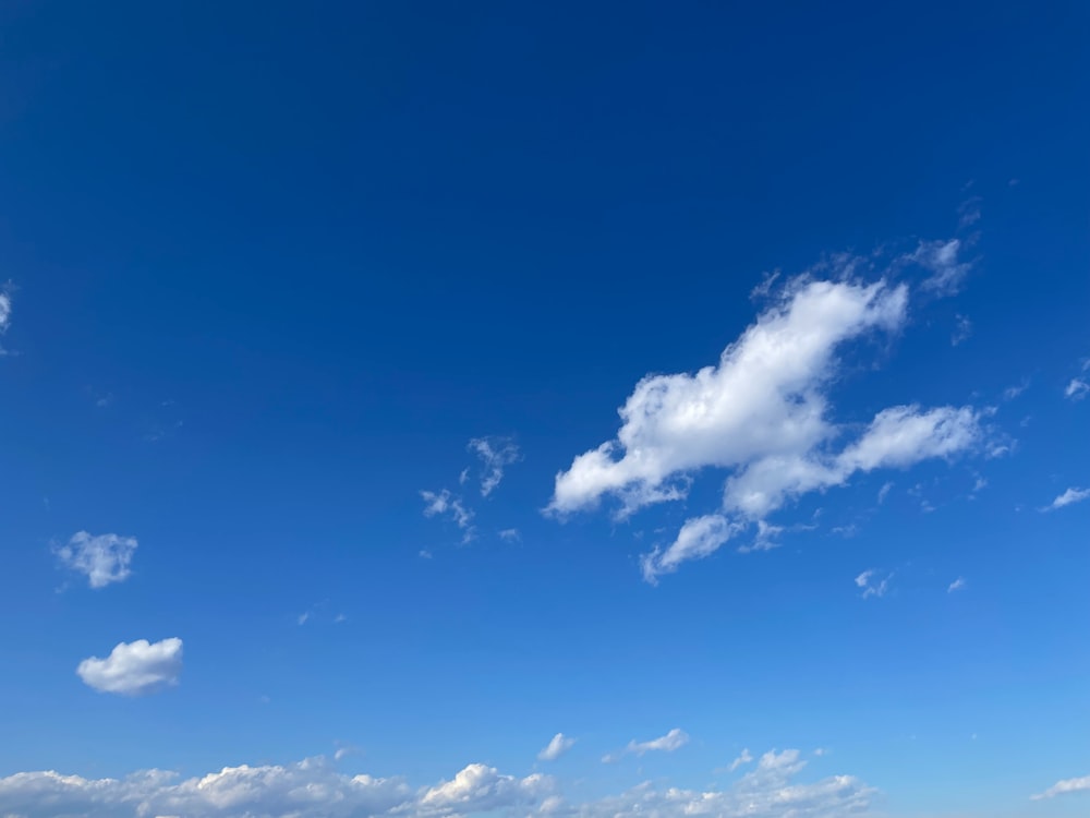 a man standing on a beach flying a kite