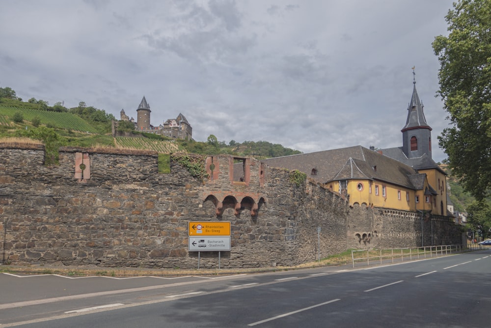 a large stone building sitting on the side of a road