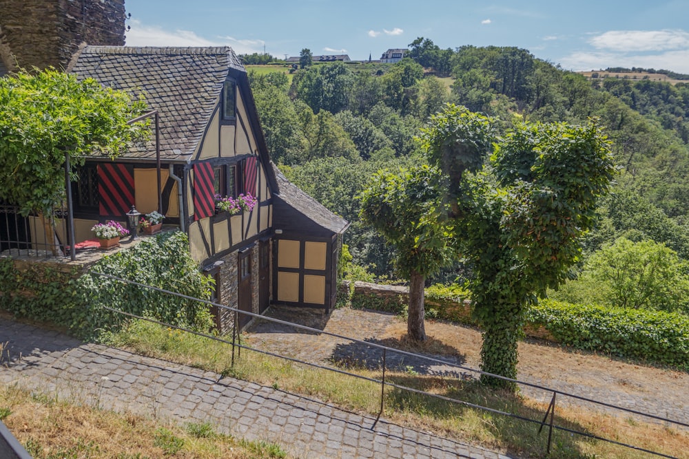 a house with a fence around it on a hill