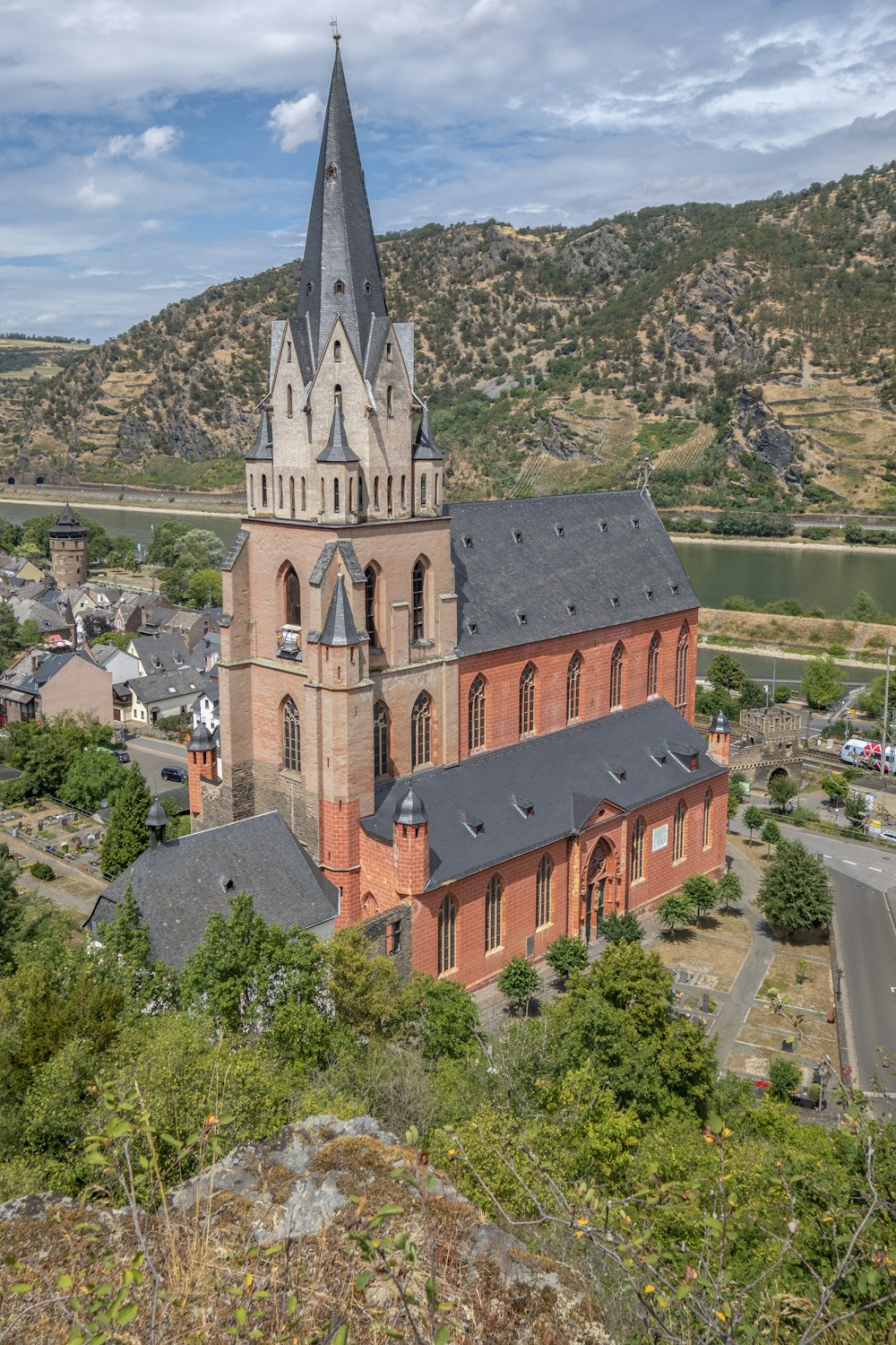 a church with a steeple surrounded by trees