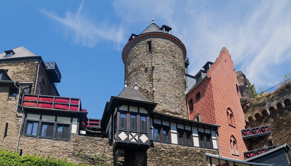 a tall brick building with a clock on it's side