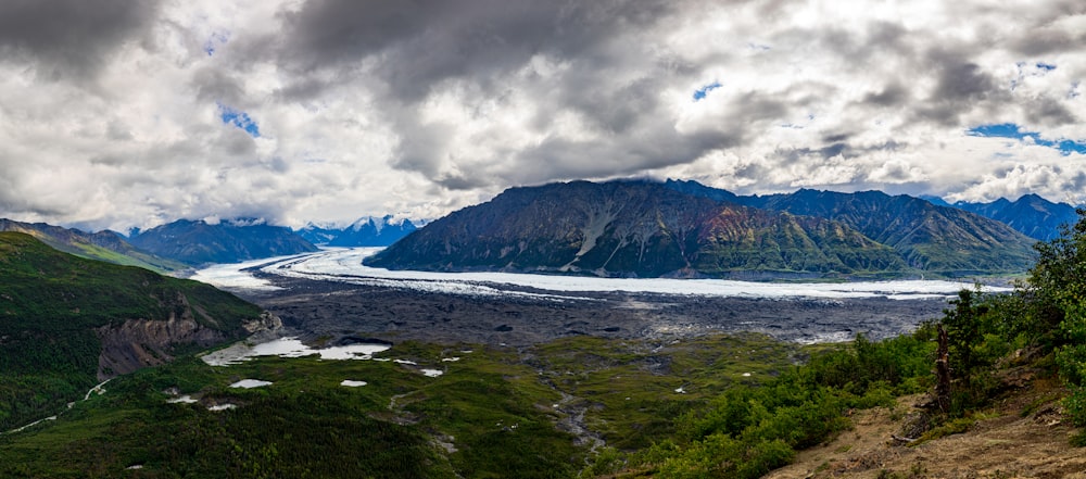 a view of a valley with a glacier in the distance