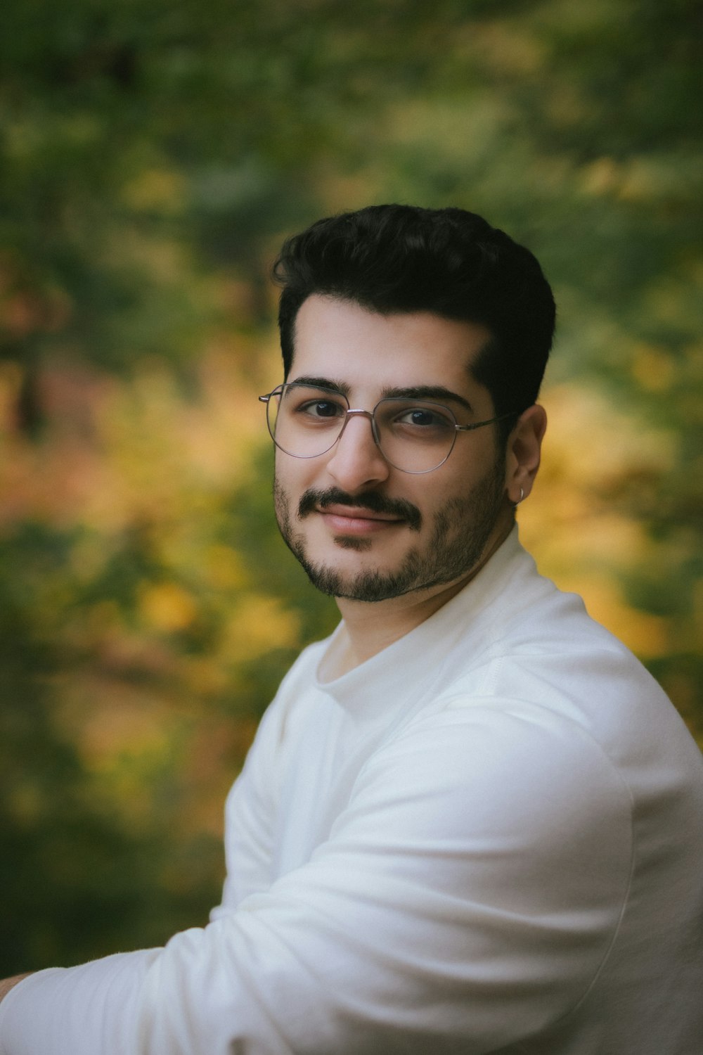 a man with glasses posing for a picture