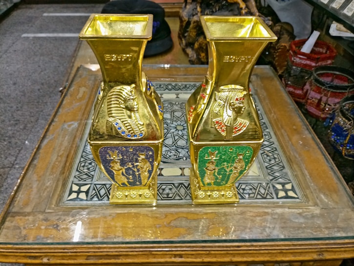 Close-up of a handcrafted Egyptian pottery vase with intricate blue and gold patterns.