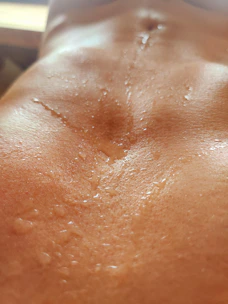 Close-up of a runner's quick-dry shirt glistening with sweat under morning light