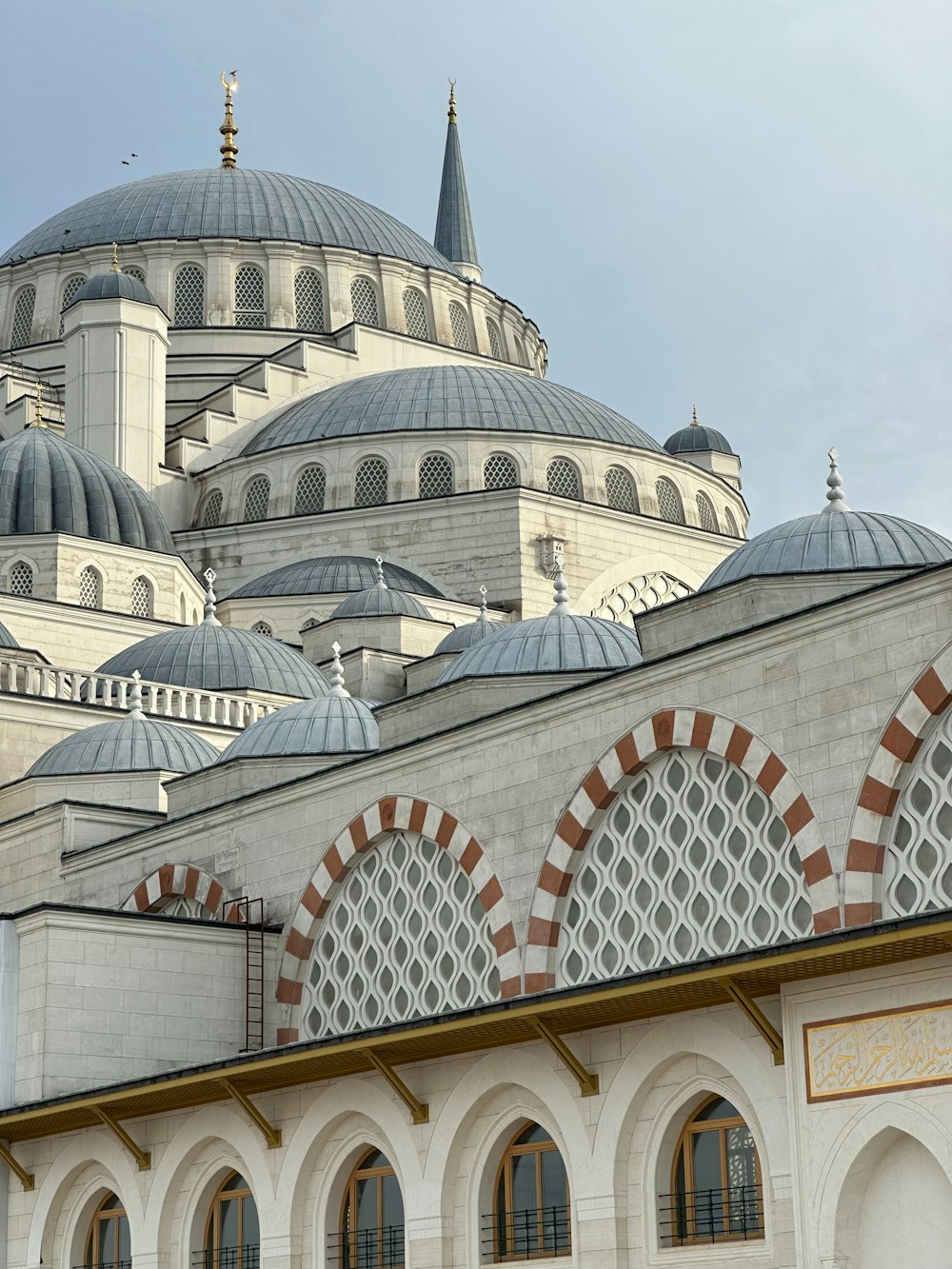 a large white building with many windows and domes