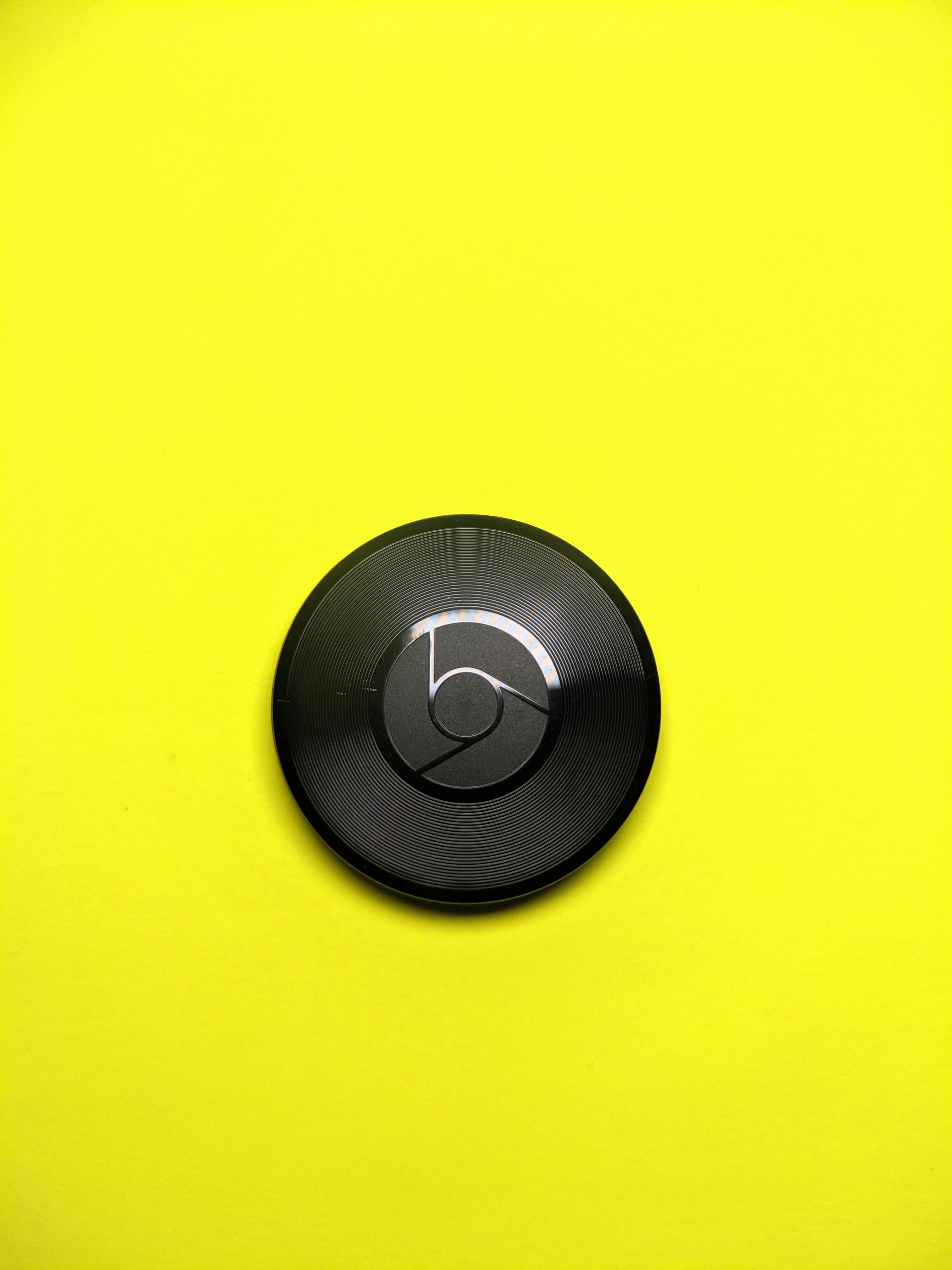 a close up of a button on a yellow surface