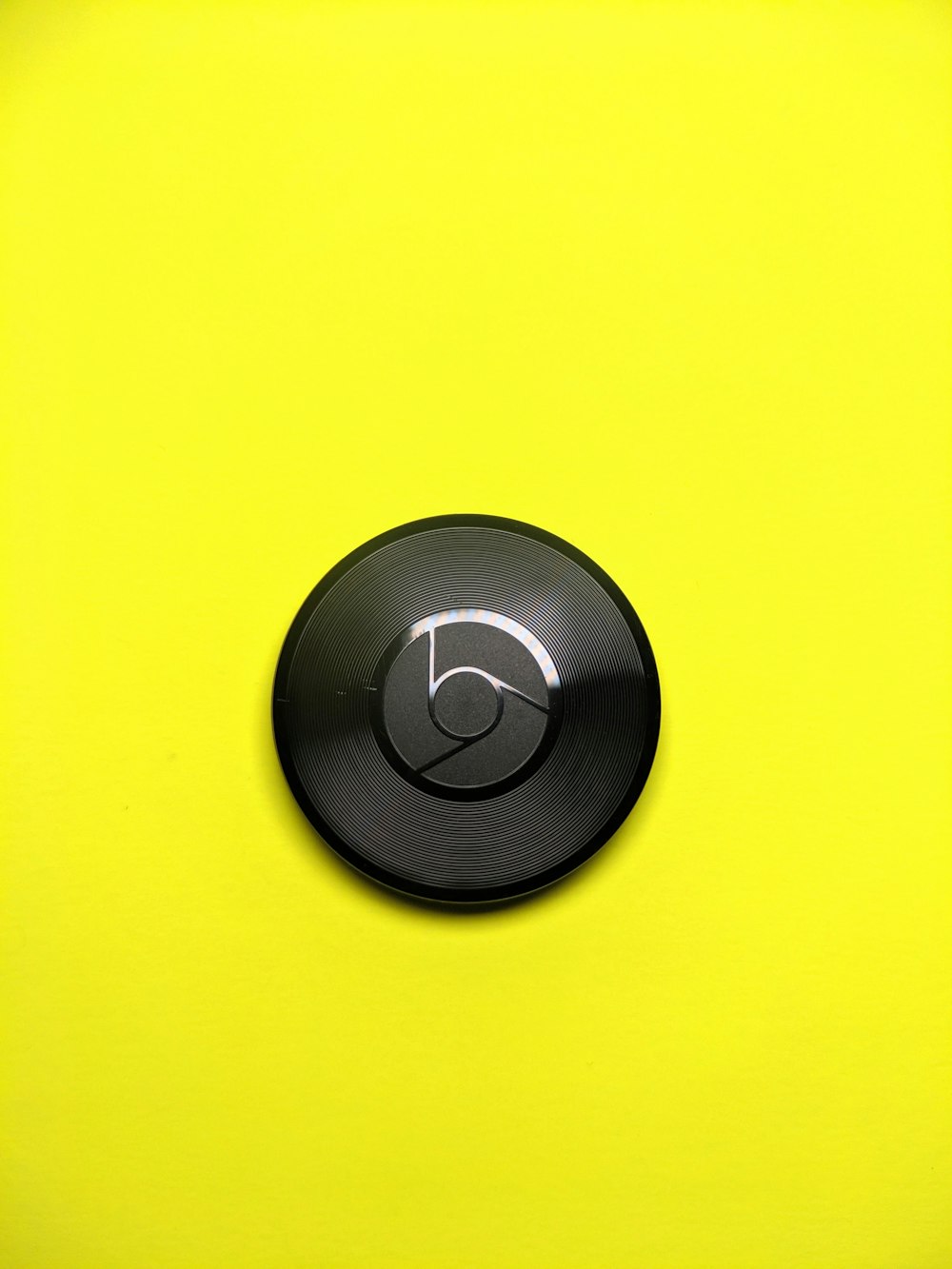 a close up of a button on a yellow surface
