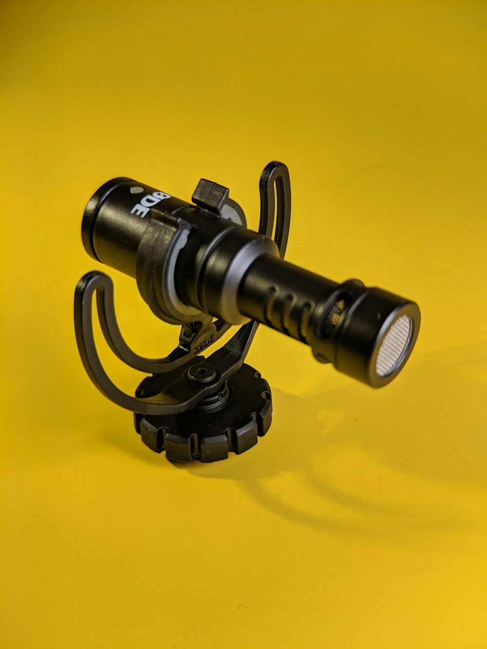 a close up of a flashlight on a yellow background